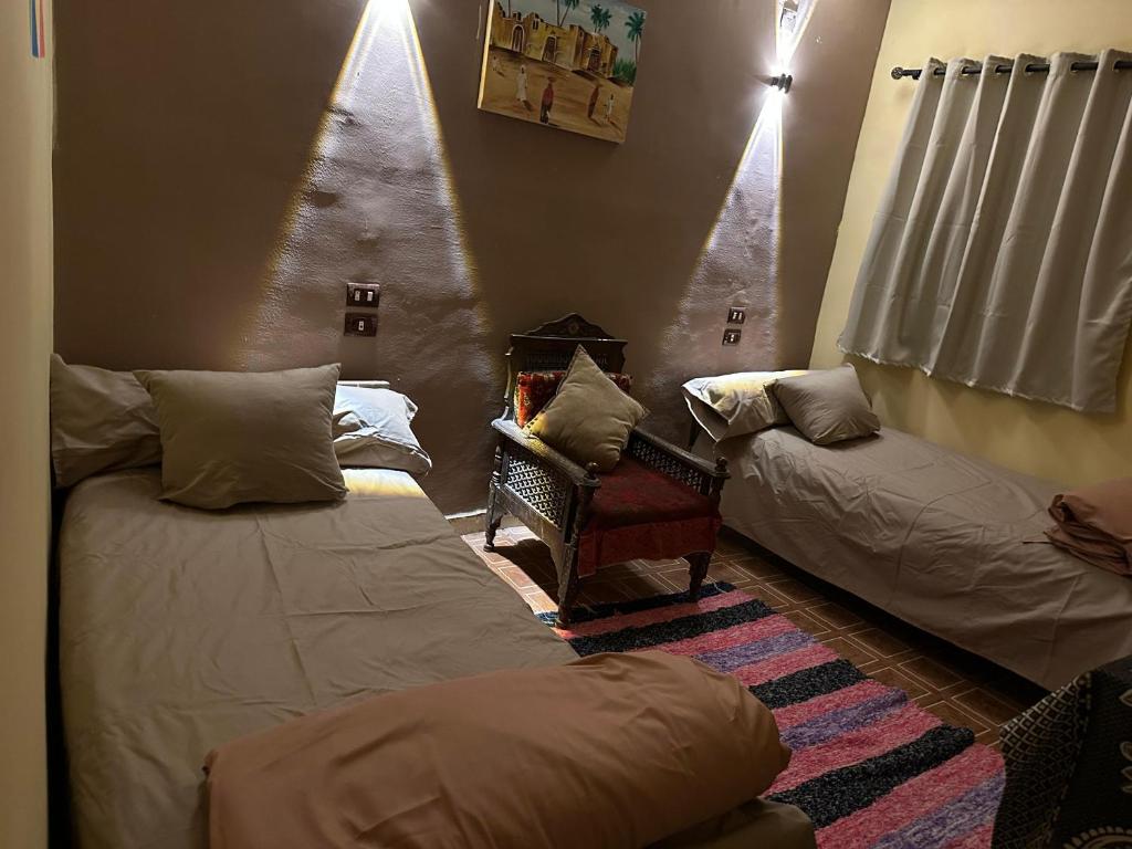 a living room with two beds and a christmas tree at SolNest Guest House in Aswan