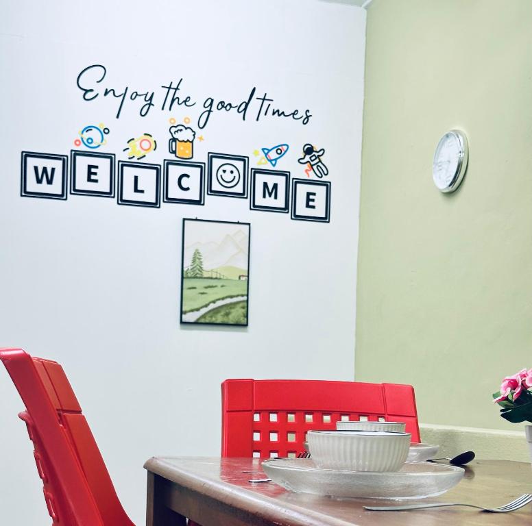 Ein Esszimmer mit einem Tisch und einem Schild mit der Aufschrift „Genießen Sie die schönen Zeiten“ in der Unterkunft Little Stay Inn in Taiping
