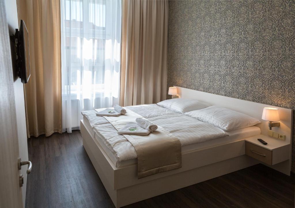 מיטה או מיטות בחדר ב-Penzion Longus
