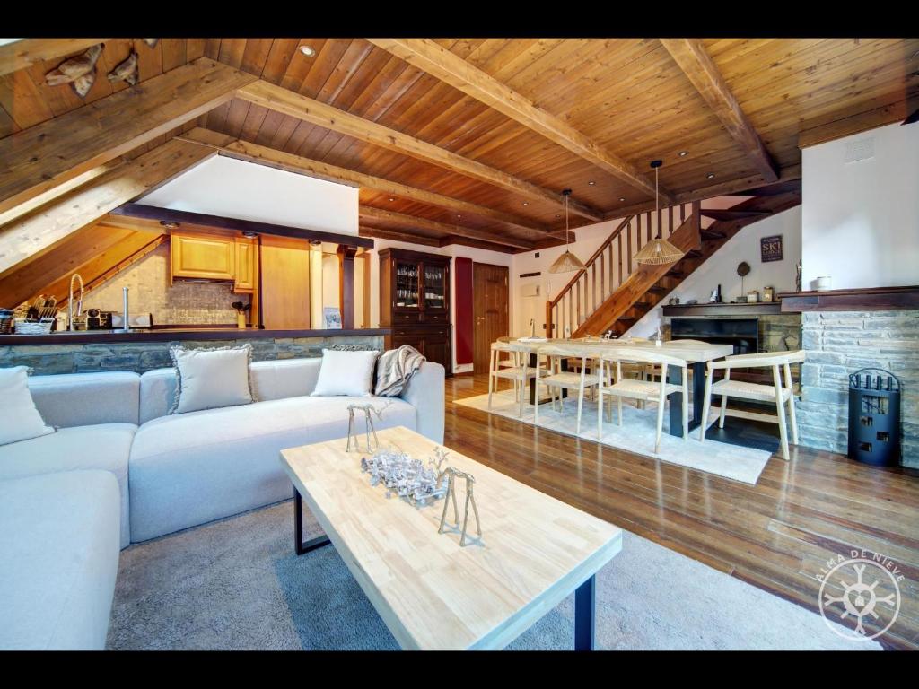 a living room with a couch and a table at ADELAIDA de Alma de Nieve in Baqueira-Beret
