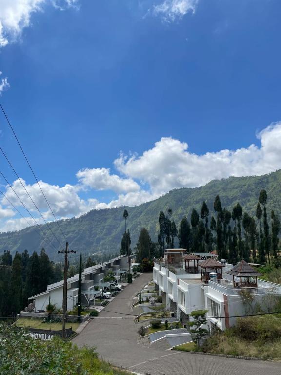 a row of buildings with mountains in the background at Orlando Hill Villa in Ngadisari