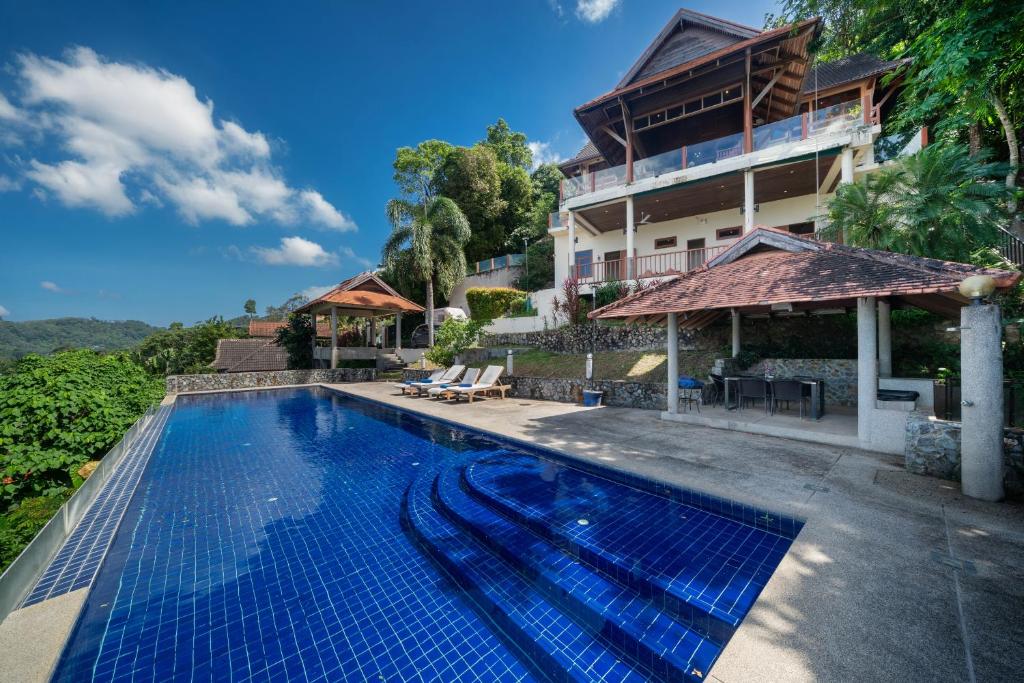 an image of a swimming pool in front of a house at Villa Moon Talay View in Patong Beach