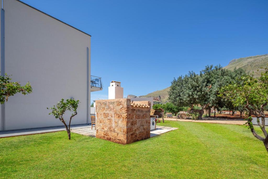 a view of the yard of a house with trees at Case Vacanza Loria in Castelluzzo
