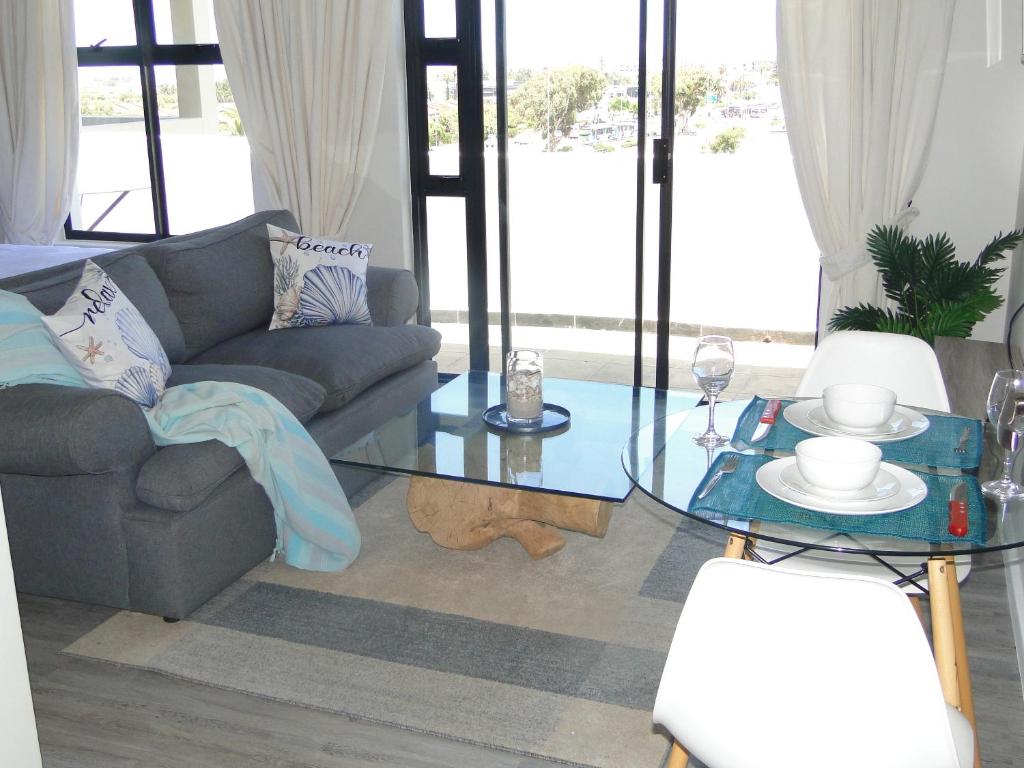 a living room with a couch and a glass table at Fresh Air in Cape Town