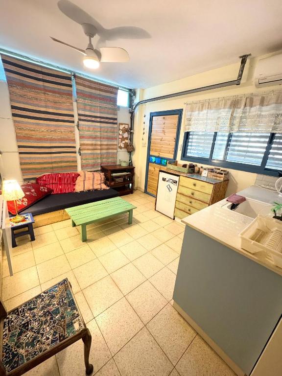 a living room with a couch and a table at צימר - יח' דיור בחוות רפאל in Pardes H̱anna