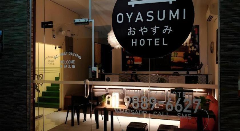 a window of a hotel with a table and chairs at Oyasumi Hotel in Kulim