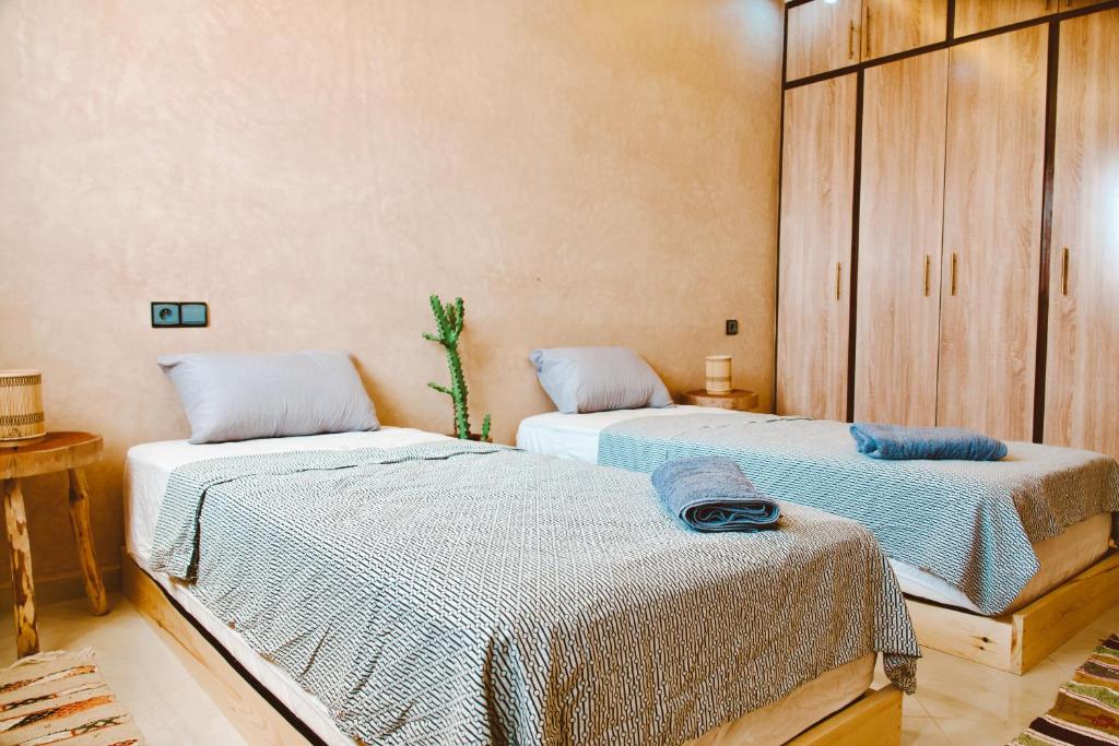 two beds sitting in a room withermottermottermott at Cool Surfers Morocco in Agadir