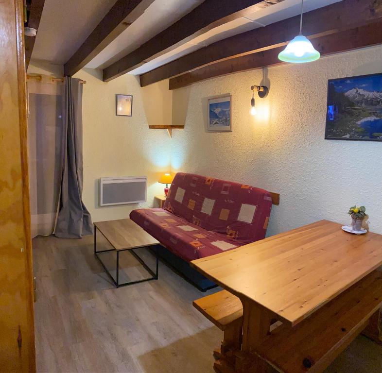 a living room with a couch and a table at Appartement Barèges centre du village in Barèges