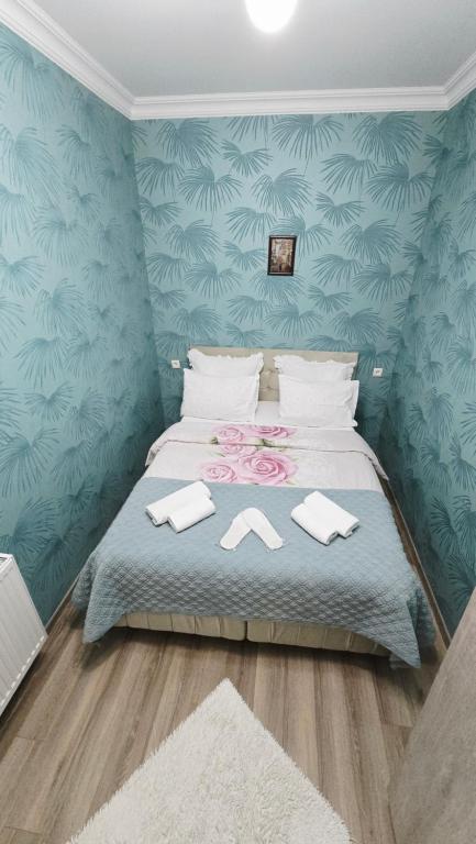 a bedroom with a bed with towels on it at Hotel bereka in Mtskheta