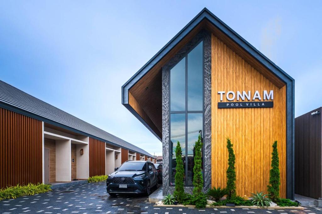 a car parked in front of a building at Tonnam pool villa in Nong Prue