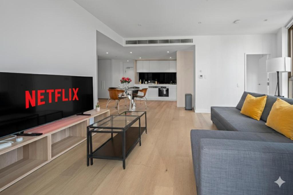 シドニーにあるCentral 2 Bedroom Condo Haymarketのソファとテレビのあるリビングルーム
