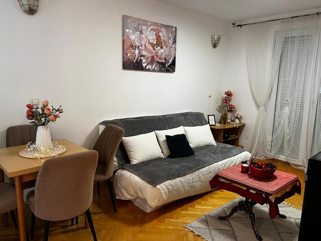 a living room with a couch and a table at Asami in Vrnjačka Banja