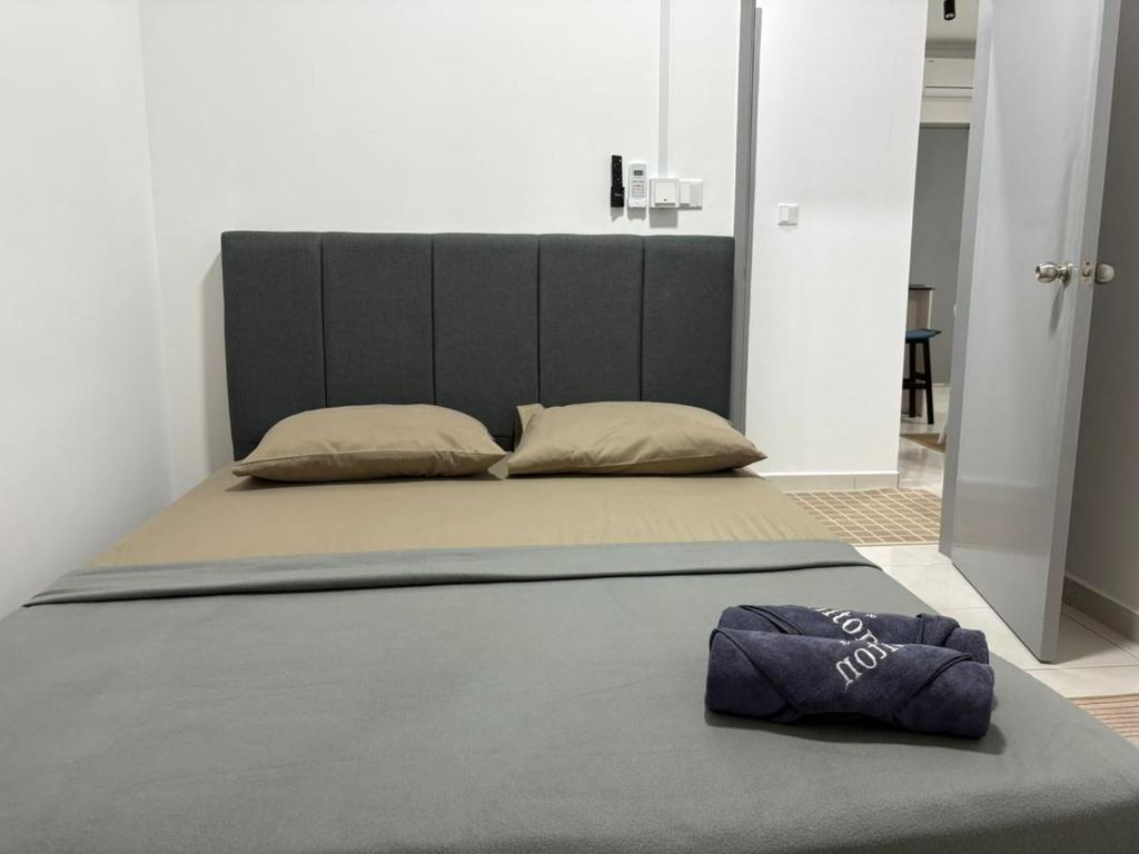 a bed with a pillow on the floor in a room at The Duta Loft in Bandar Puncak Alam