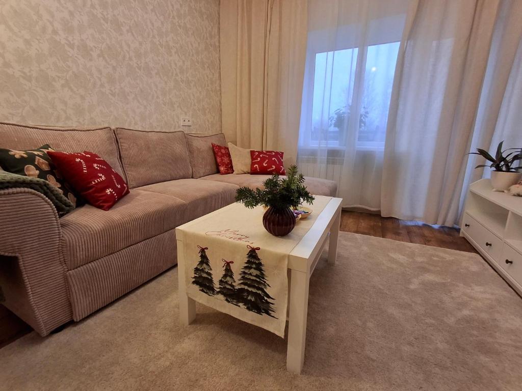 a living room with a couch and a coffee table at Tammiku apartment in Kunda