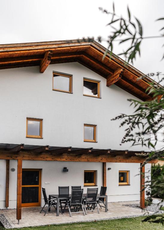 a group of chairs in front of a house at Sandi`s Ferienhaus in Reutte