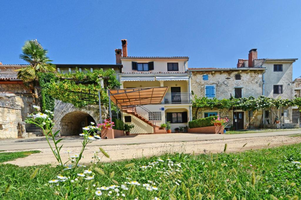 a large house with a wooden staircase in front of it at Apartment LILI in Poreč