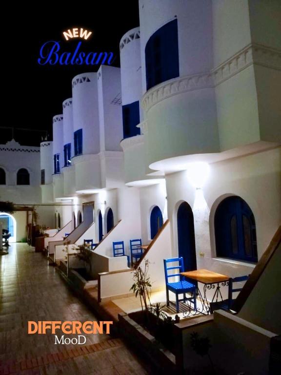 a building with chairs and a table in a courtyard at Balsam hotel in Dahab