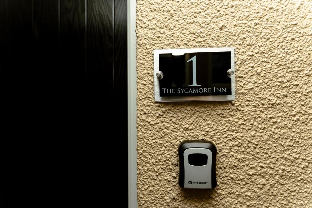 a sign on the side of a wall with a cell phone at The Sycamore Inn in Birch Vale