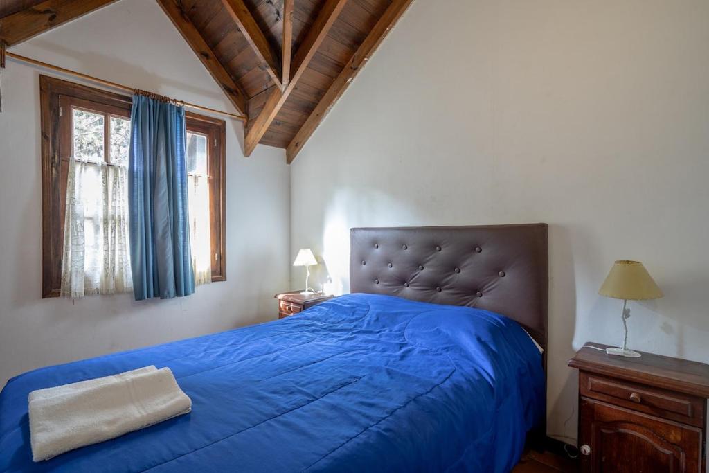 En eller flere senge i et værelse på Pinamar De La Lisa