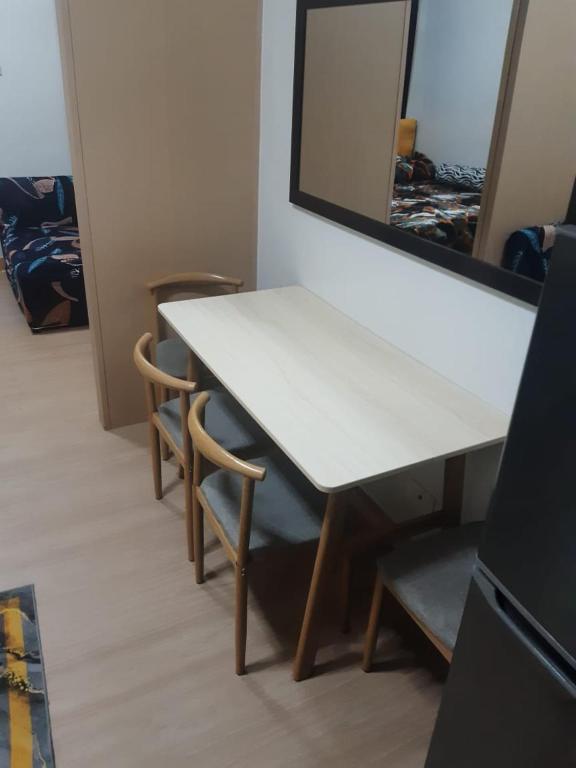 a white table with two chairs and a mirror at My Space Your Privacy in Manila