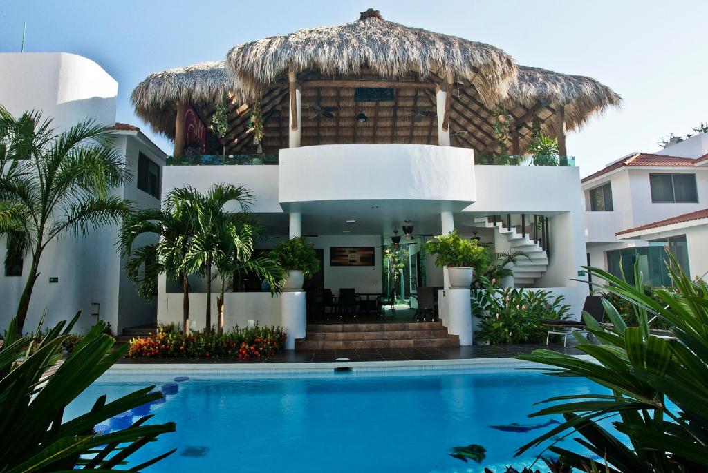 a villa with a swimming pool and a resort at Villas Maria Isabel in Santa Cruz Huatulco