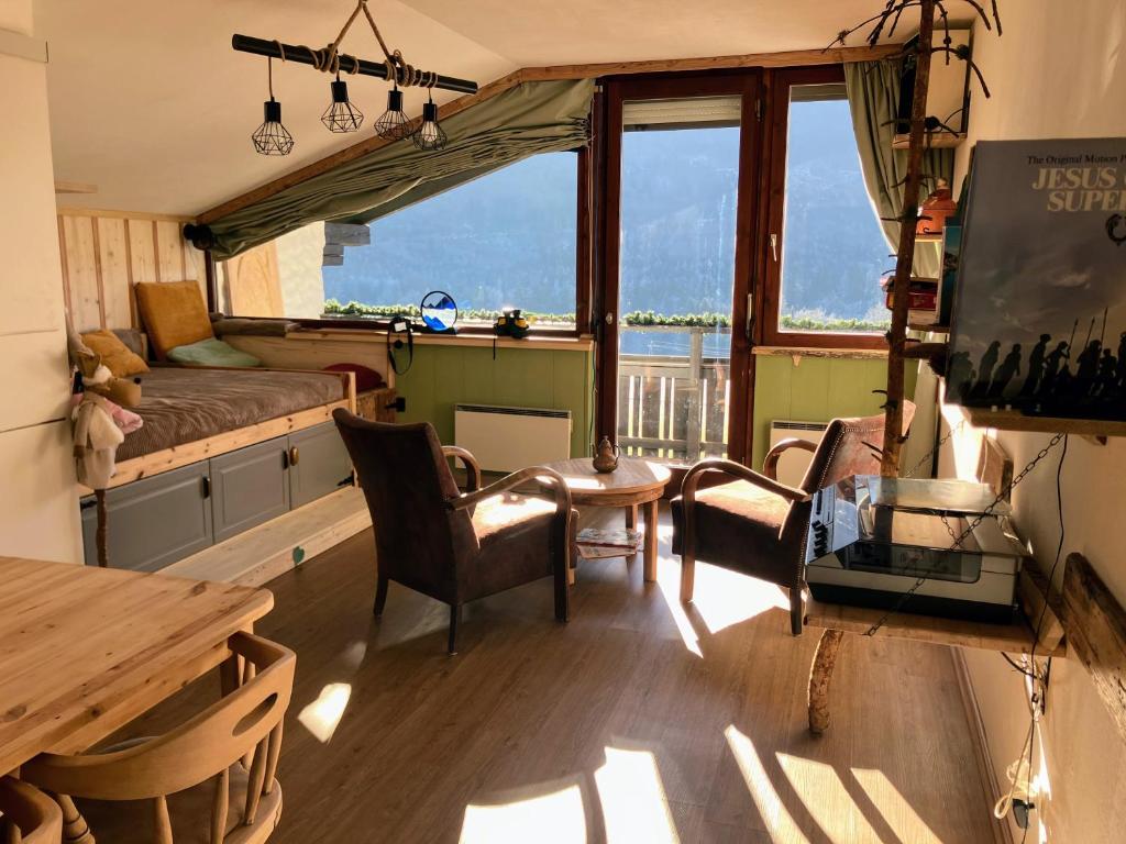 a living room with a bed and a table and chairs at Dachstein Stüberl in Bad Aussee