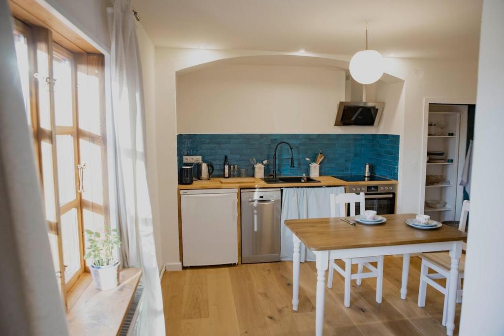 a kitchen with a wooden table and a table and a table and a tableablish at Apartment mit Connection am Müritz National Park 