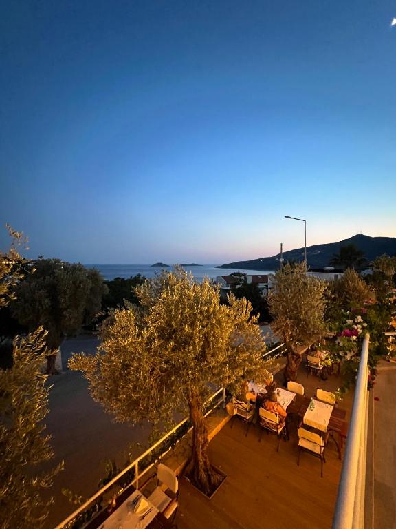 a view of a balcony with chairs and trees at The Bay View Hotel Kalkan in Kaş