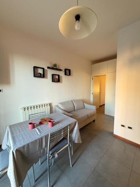 a living room with a table and a couch at La Dimora di Siena in Tognazza