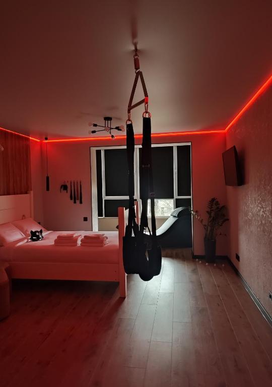 a room with a bed with red lights on it at Тематичні апартаменти in Zhytomyr