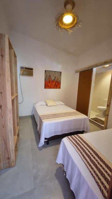 Ένα ή περισσότερα κρεβάτια σε δωμάτιο στο Pura Vida Hostel e Pousada - Boipeba