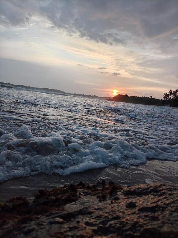 a view of the ocean at sunset at White Shell in Tangalle