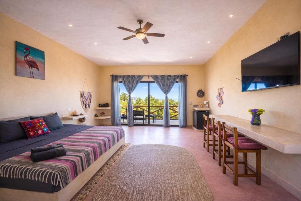 a bedroom with a bed and a table with chairs at Atenea Holbox in Holbox Island
