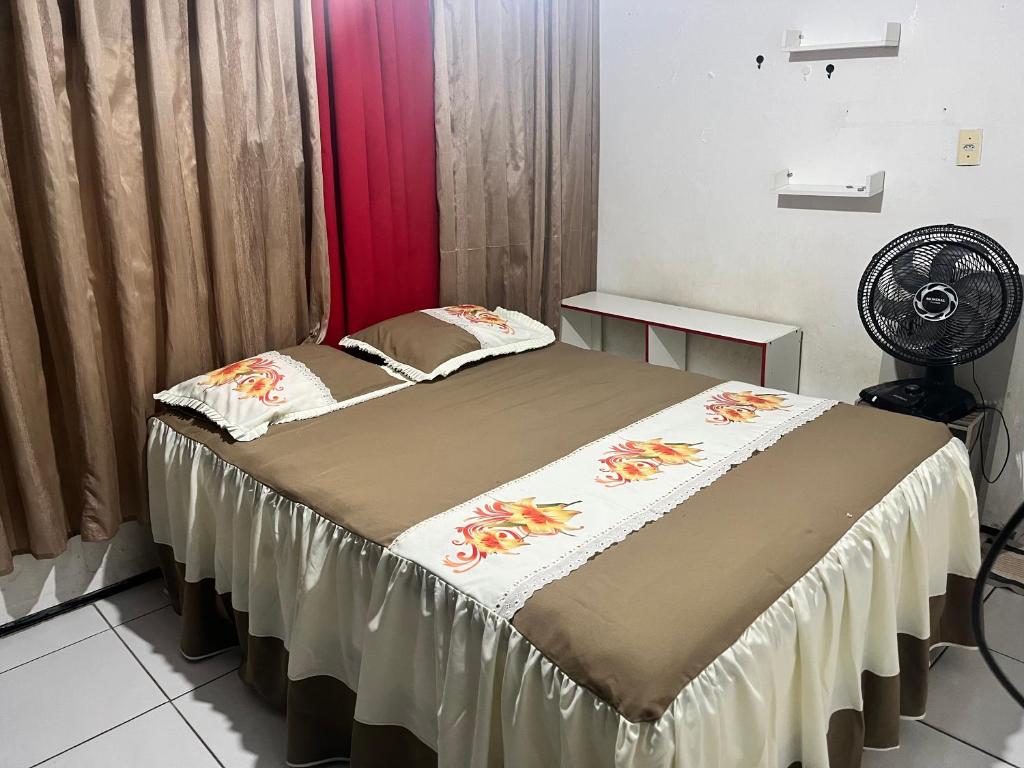 Bett in einem Zimmer mit einem roten Vorhang in der Unterkunft Chácara do Sossego in Viçosa do Ceará