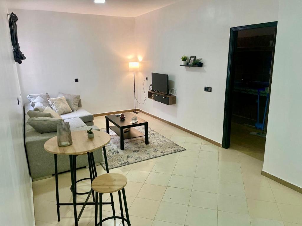 a living room with a couch and a table at Le bon coin in Casablanca