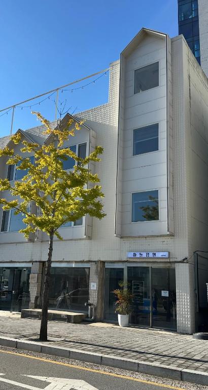 a building with a tree in front of it at 하늘정원 in Gwangju