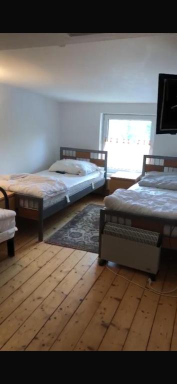 a bedroom with two beds and a window at Auszeit in Hamburg