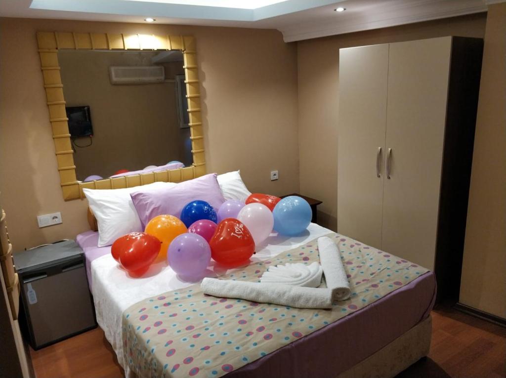 a bunch of balloons sitting on top of a bed at Gvar Hotel ANTALYA in Antalya
