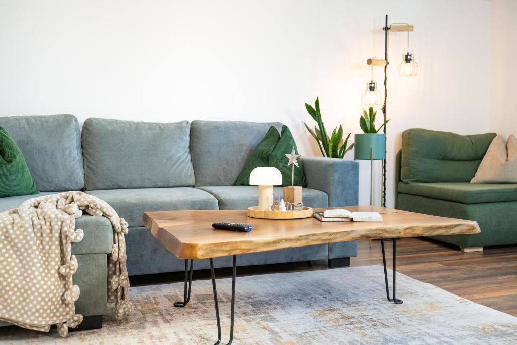a living room with a couch and a coffee table at Dili Appartement in Altenmarkt im Pongau