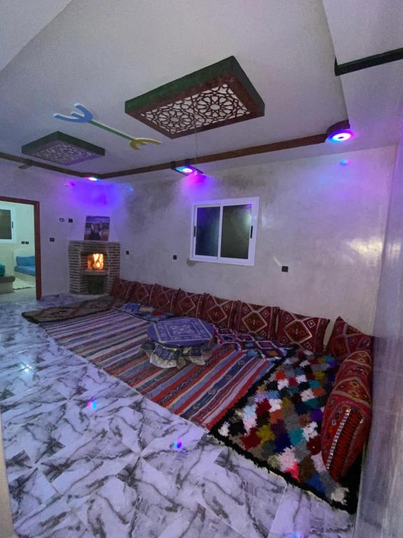 een woonkamer met een bank en een open haard bij Adrar N Darn Guesthouse in Taroudant