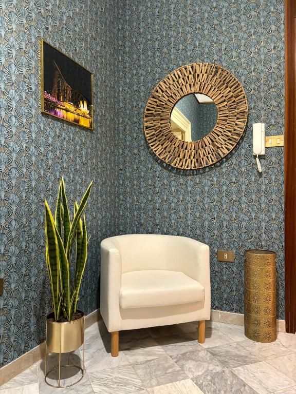 a living room with a chair and a mirror at Vintage Rooms in Palermo