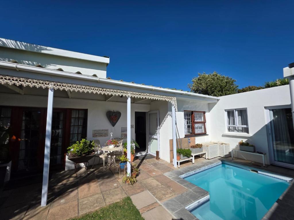 a house with a swimming pool in the yard at Alvera in Strand