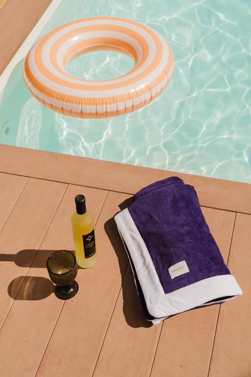 a pool with a frisbee and a towel next to a swimming pool at Canaryislandshost l The Sky Suites in Tinajo