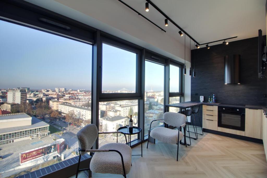 a kitchen with a view of a city at Apartament Loft Olszynki Park in Rzeszów