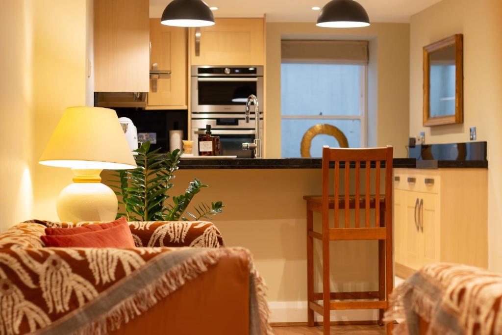 un soggiorno con divano e cucina di Garden flat a Bath
