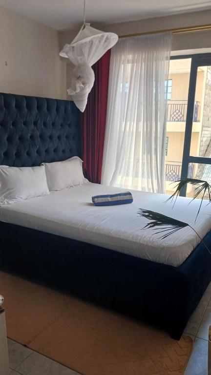 En eller flere senge i et værelse på Tsavo Brian