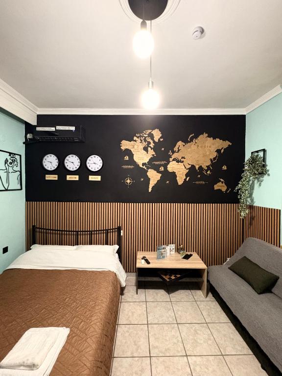 a bedroom with a bed and a map on a wall at Folia studio Φωλιά στούντιο - myHomee in Xanthi