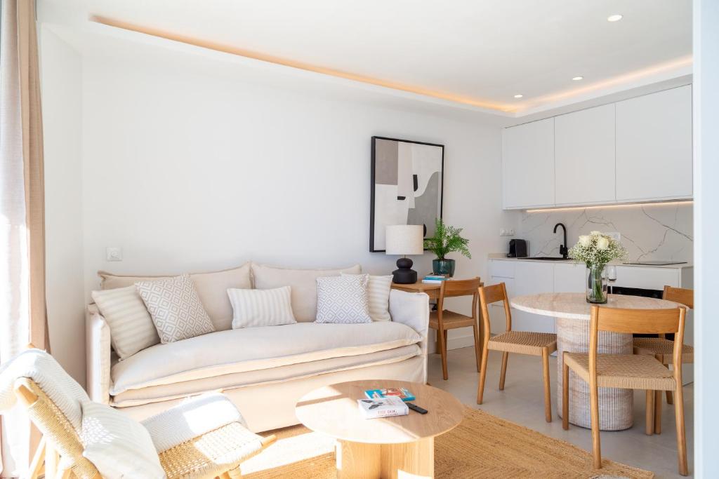 a living room with a white couch and a table at Boutique Apartment with Sun Terrace & Sea Views in Torremolinos