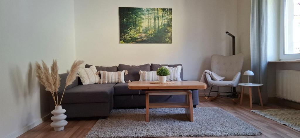 a living room with a couch and a table at Ferienwohnung Thomas in Adenbach