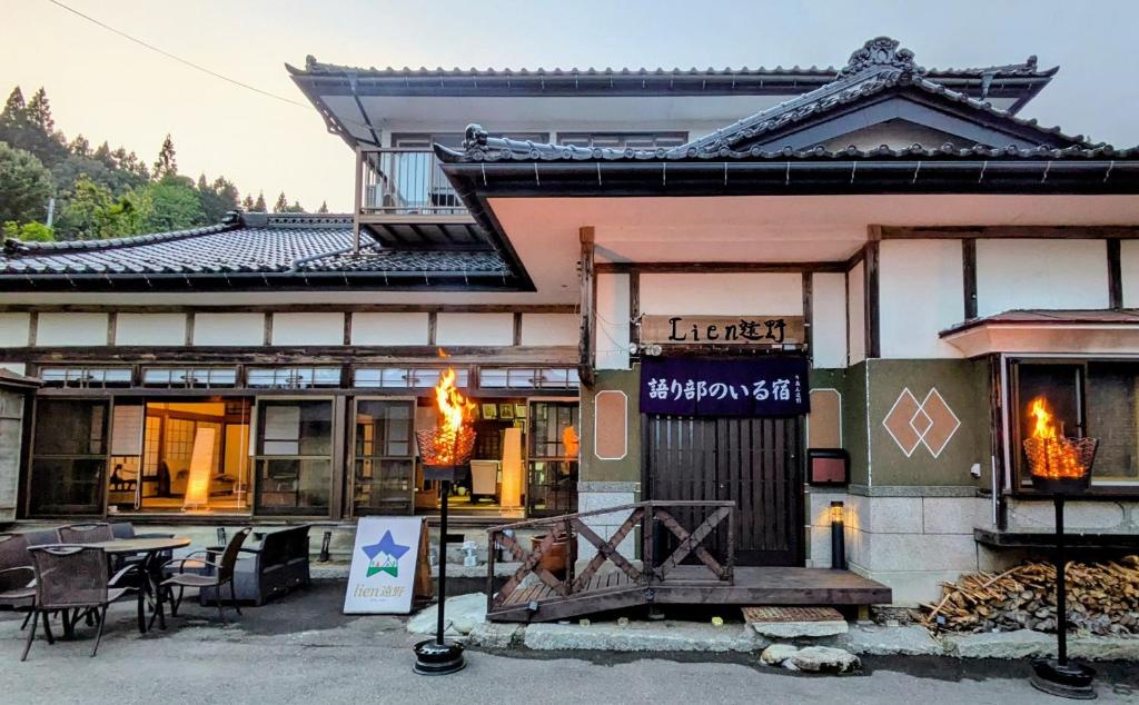 a building with a table in front of it at Lien Tono in Tōno